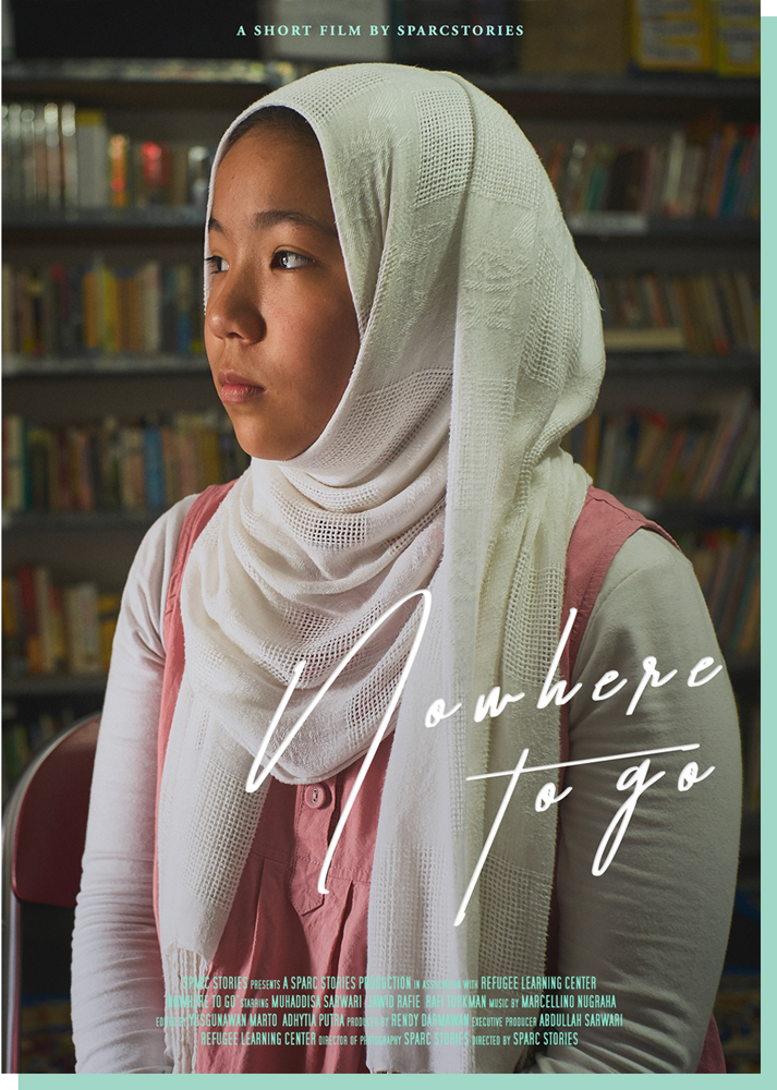 Nowhere To Go movie poster featuring Muhaddisa, an Afghan girl wearing a white hijab and a rose colored jumper in a library